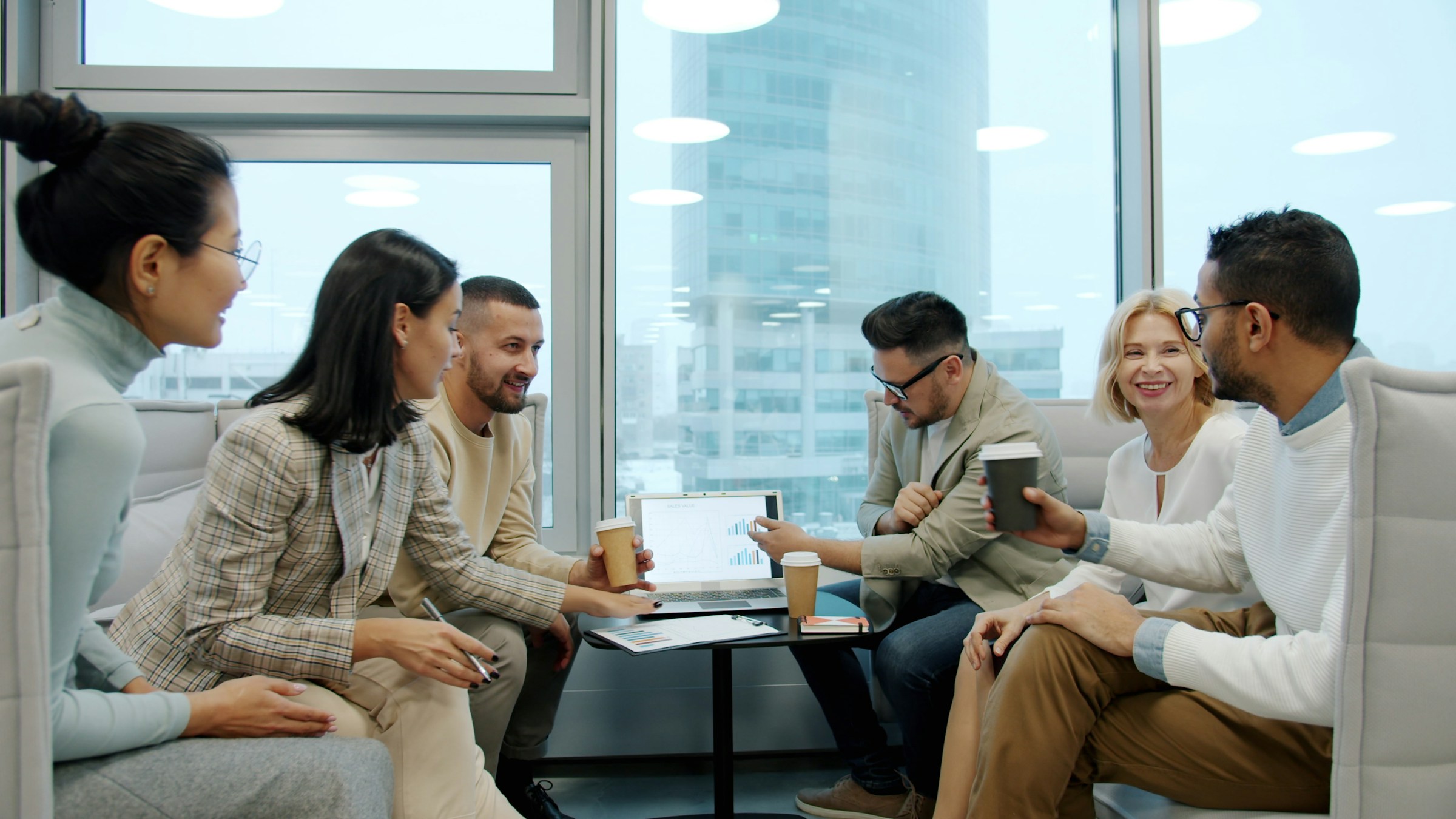 Professionals in a shared office conversation