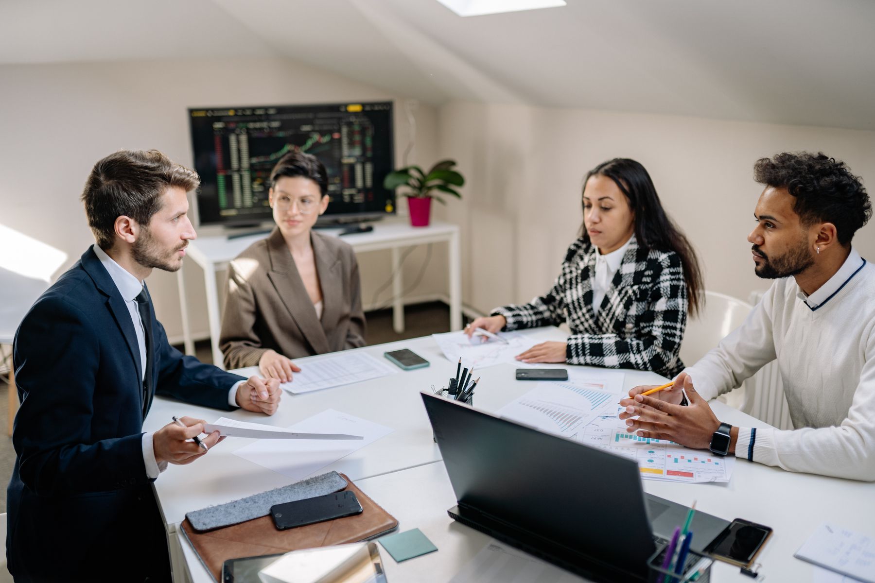 Professionals discussing workplace reports in a meeting